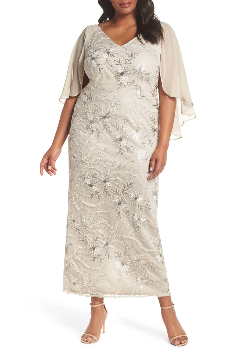 Woman in cream gown with embroidery standing in ivory room