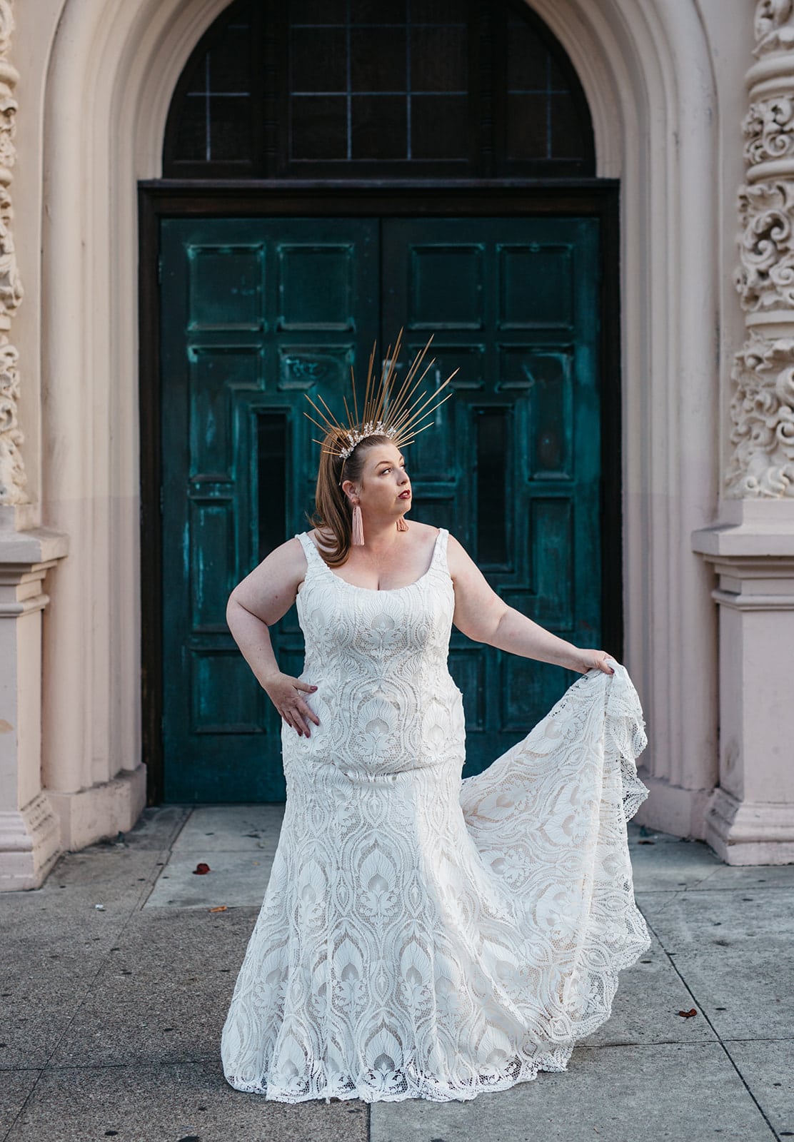 A woman wears a lace sheath plus size wedding dress from APW x Lace & Liberty collection