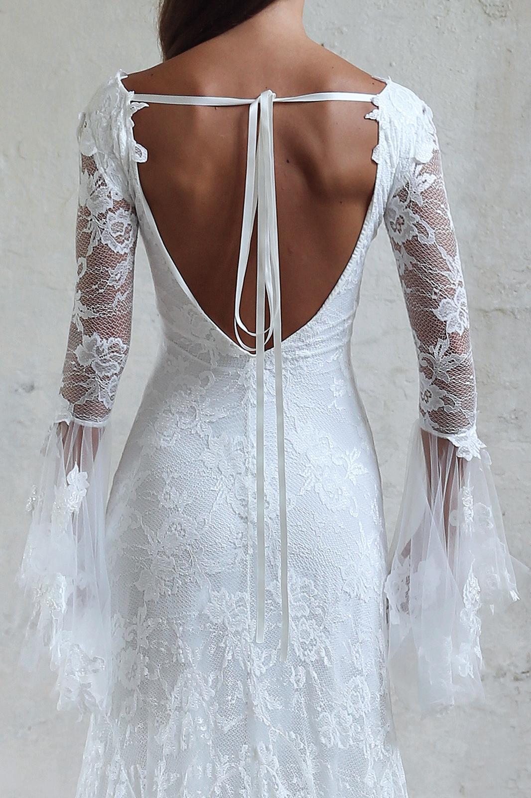 Back of woman wearing white lace gown