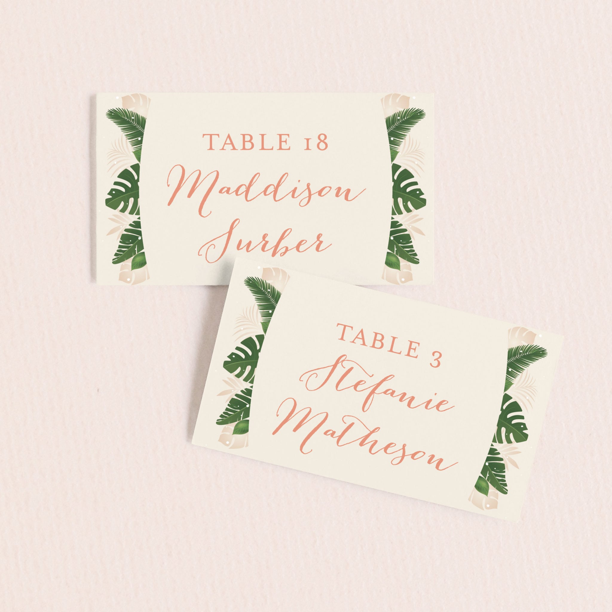 two wedding place cards with tropical monstera leave print