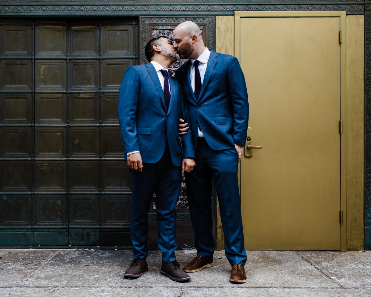 Two grooms kiss at City Hall