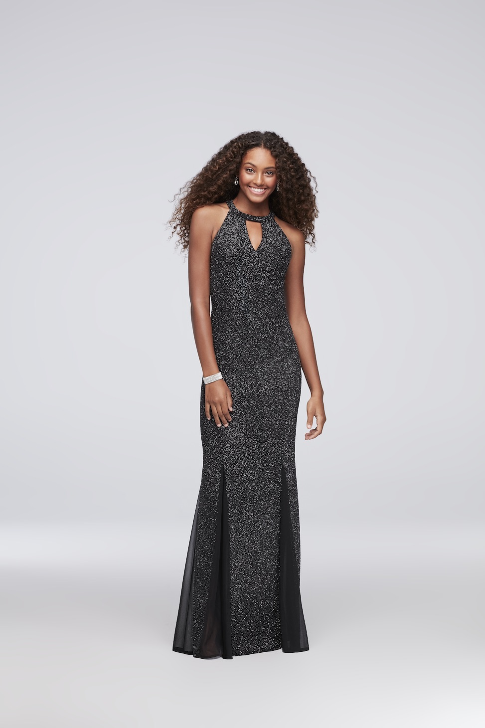 product image of a model wearing a high neck sparkling black evening gown from david's bridal with a keyhole cutout
