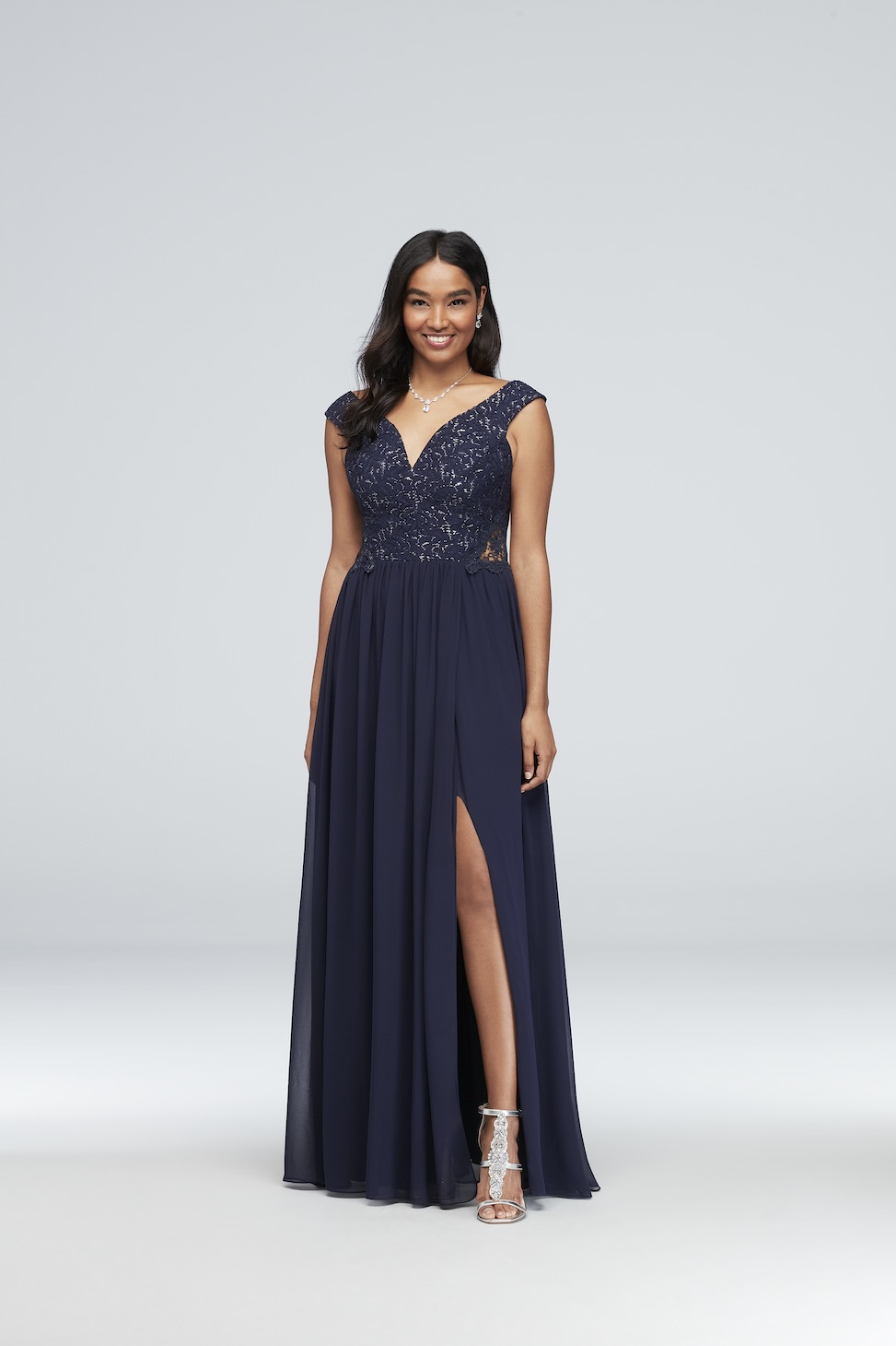 product image of an off-the-shoulder navy blue sequin evening gown from david's bridal with cutouts and lace details plus a side slit