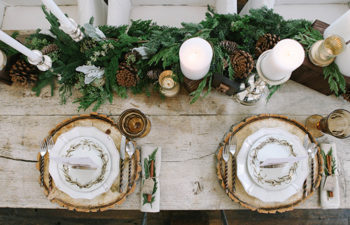 Table setting with wood slices and fir table runner