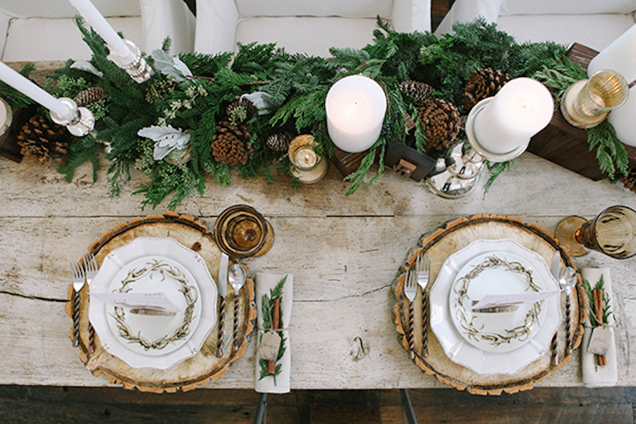 Table setting with wood slices and fir table runner