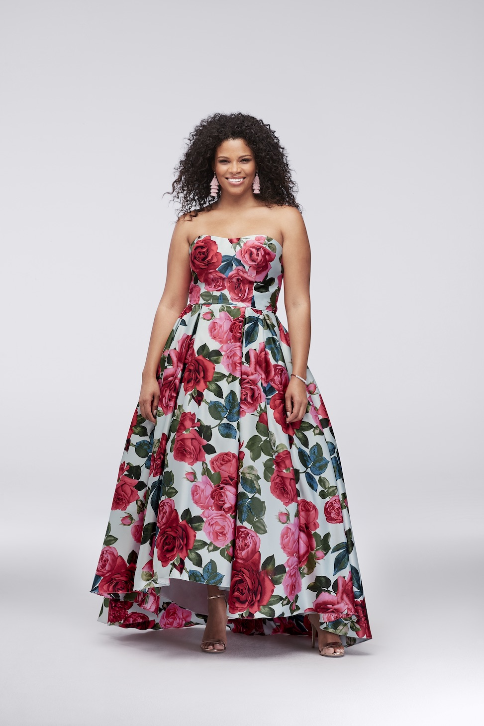 plus size woman wearing a high-low satin strapless floral evening ball gown from david's bridal