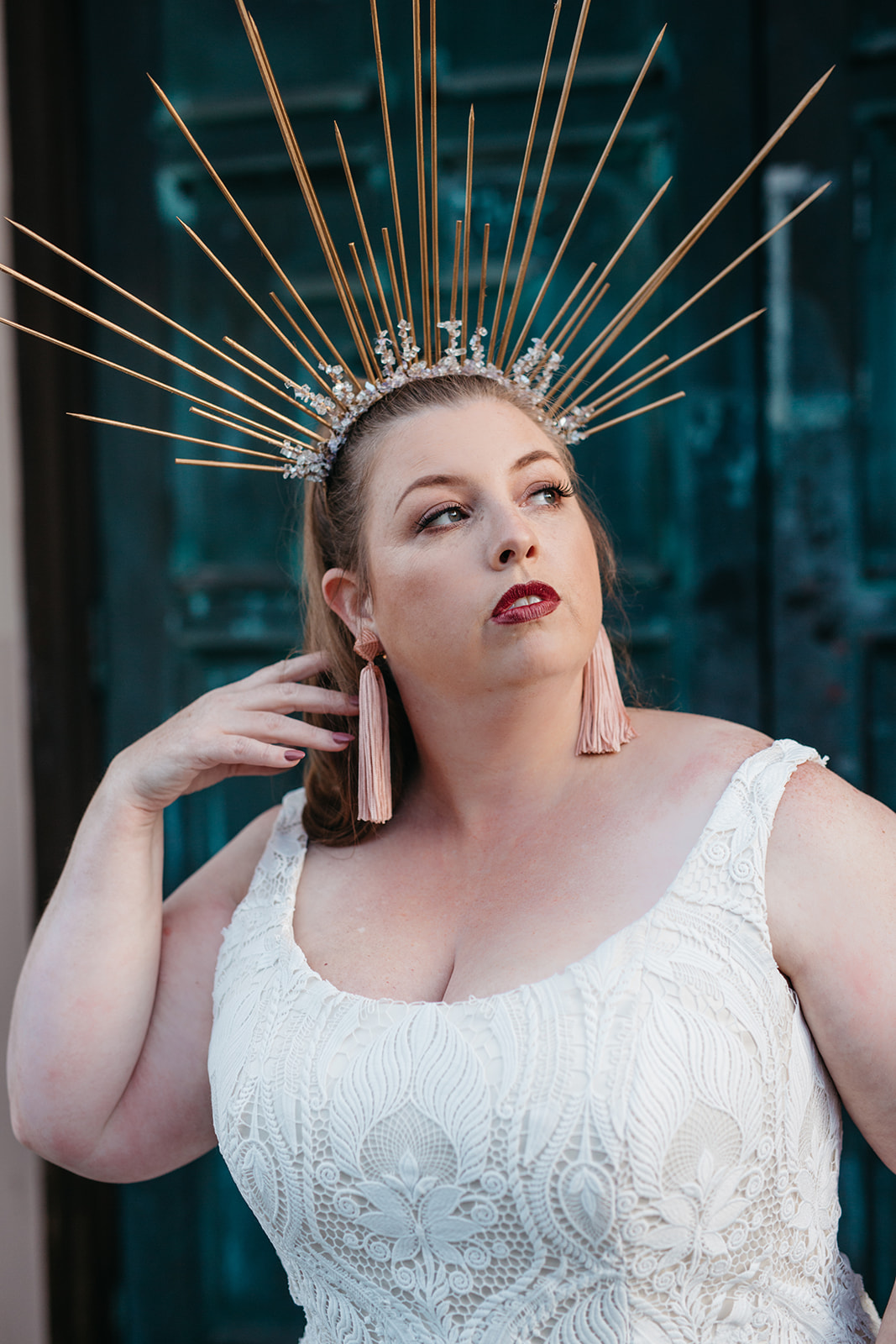 close up of model in scoop neck all over lace plus size sheath wedding gown and a DIY heavenly bodies crown from the a practical wedding plus size wedding dress collection