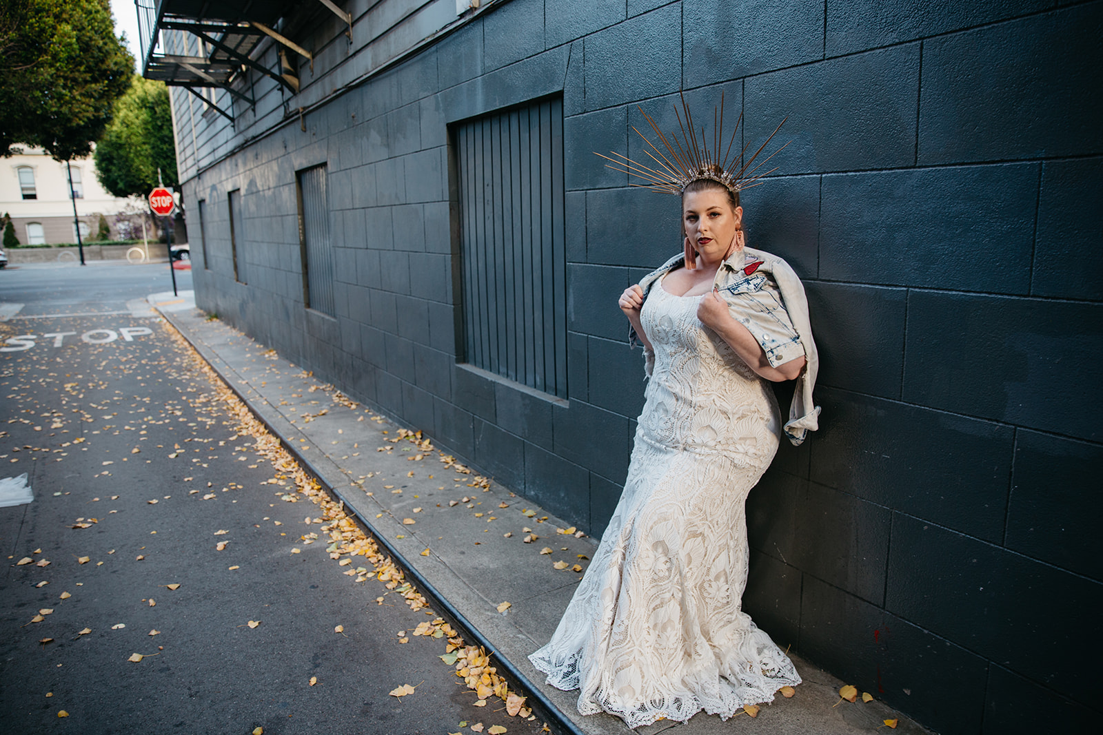 plus size model wearing an all over lace scoop neck wedding gown from the a practical wedding plus size wedding dress collection