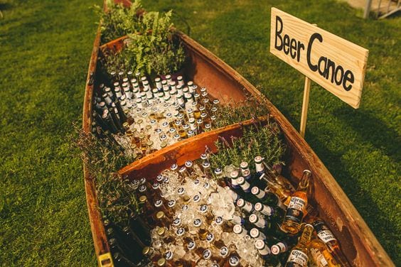 wedding ideas for beer in a canoe with a yard sign that reads "Beer Canoe"