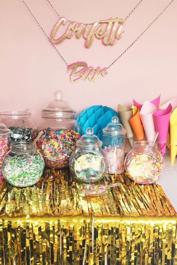 wedding ideas—a table with jars of confetti and paper cones to fill. A glittery sign above the table reads "Confetti Bar"