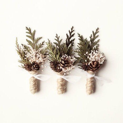 Three boutonnières in winter wedding colors: fir and pinecones