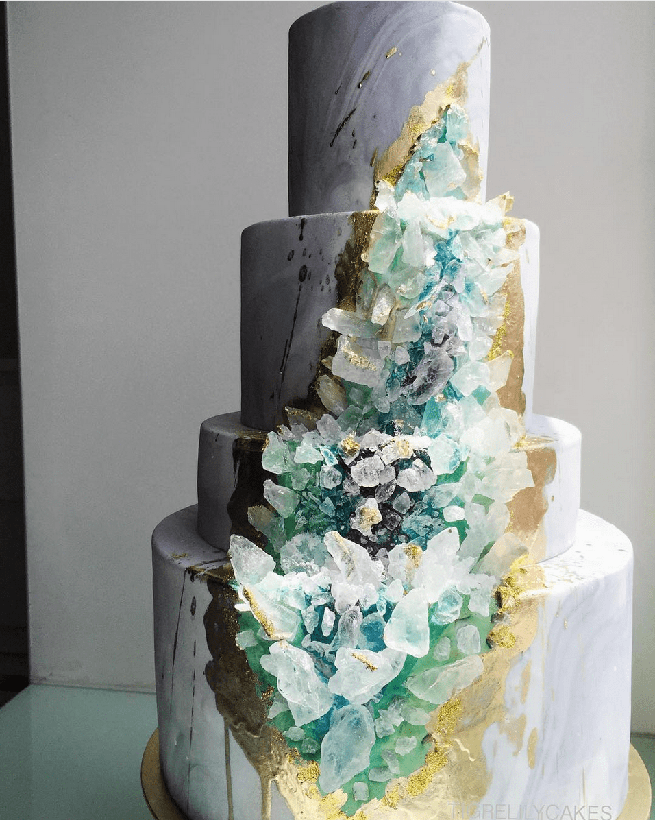 Winter wedding ideas for a tiered wedding cake with teal and white crystals embedded inside