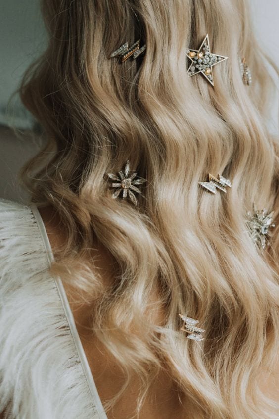 wedding ideas for hair accessories—lighting bolt and star hair jewelry adorning long blond waves