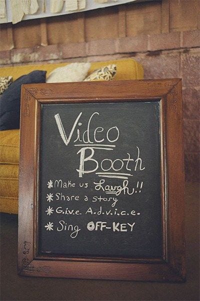 wedding ideas for a video booth chalk board sign, which reads "Video Booth *make us laugh!! *share a story *G.i.v.e A.d.v.i.c.e. * Sing off-key"