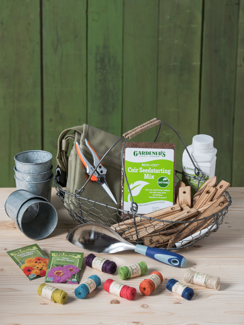 the best gift basket for gardeners filled with flower seeds, twine, sheers, pots, and herb markers