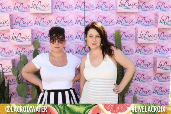 Meg and Maddie wearing summery clothes posing in a multi-image gif in front of cacti and a wall of pink La Croix