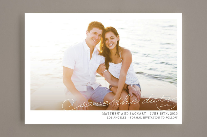 Minted save the date couple sitting on the beach