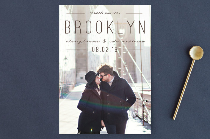 Minted save the date couple walking on the Brooklyn Bridge