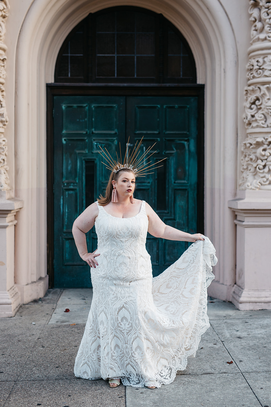 model wearing a scoop neck all over lace plus size wedding gown from the a practical wedding plus size wedding dress collection