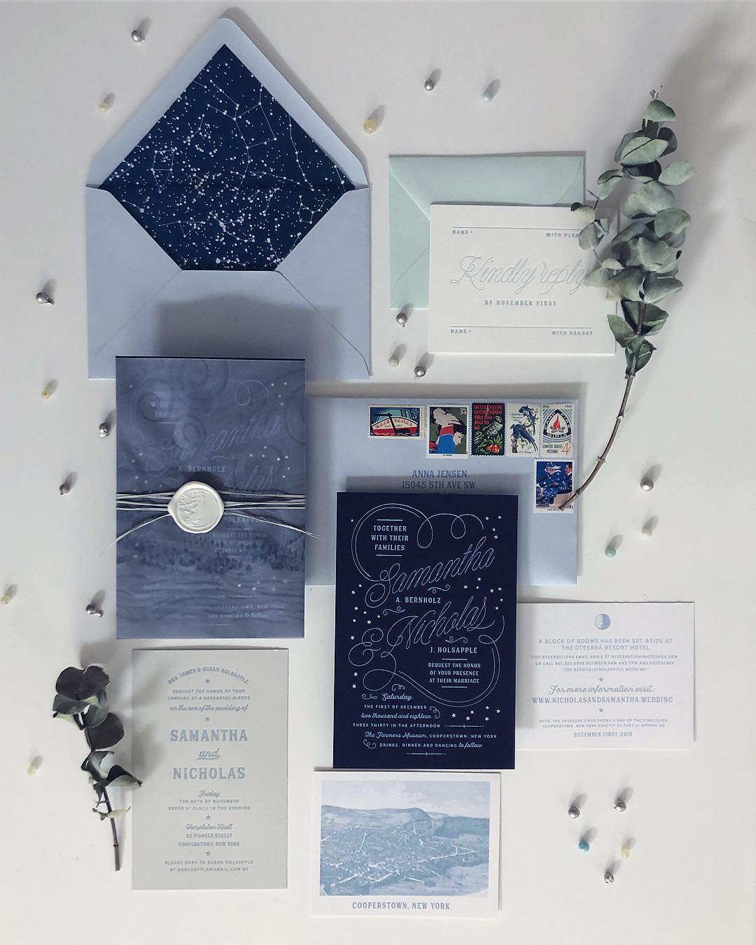 flat lay of blue-colored star-themed wedding invitation suite with letterpress printing by Thomas Printers