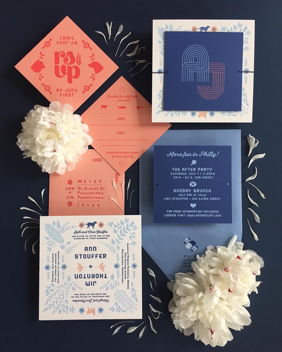 flat lay of coral and navy-colored wedding invitation suite with affordable letterpress printing by Thomas Printers