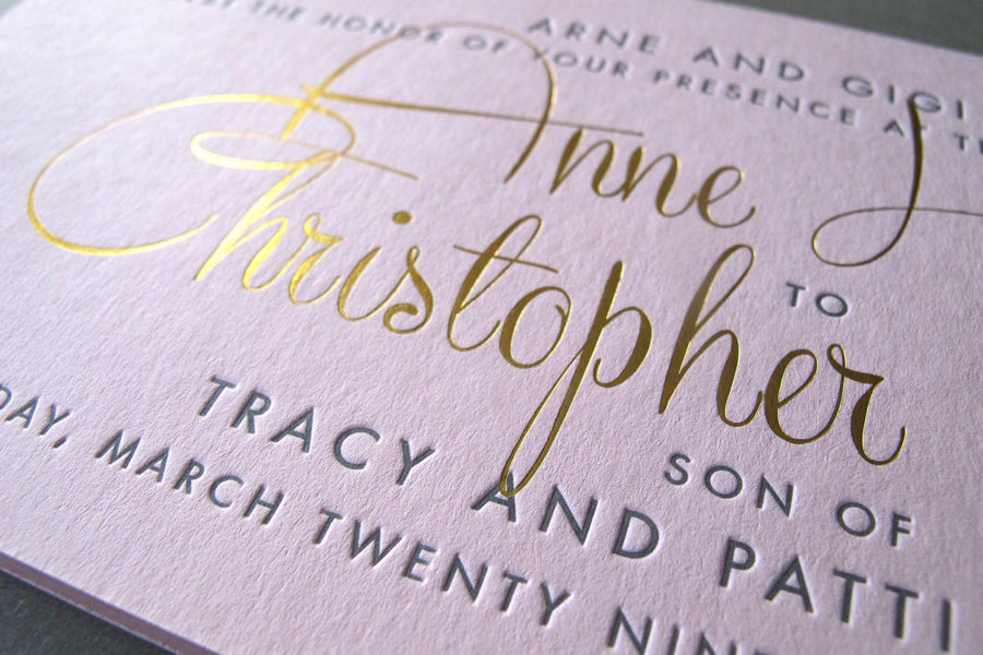 Close up of an affordable letterpress invitation by Thomas-Printers with gold foil accents, and a combination of gold script and grey sans serif type