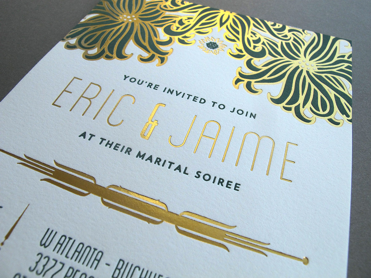 close-up shot of letterpress wedding invitation to Eric & Jaime's marital soiree by Thomas Printers featuring green flowers and gold foil details