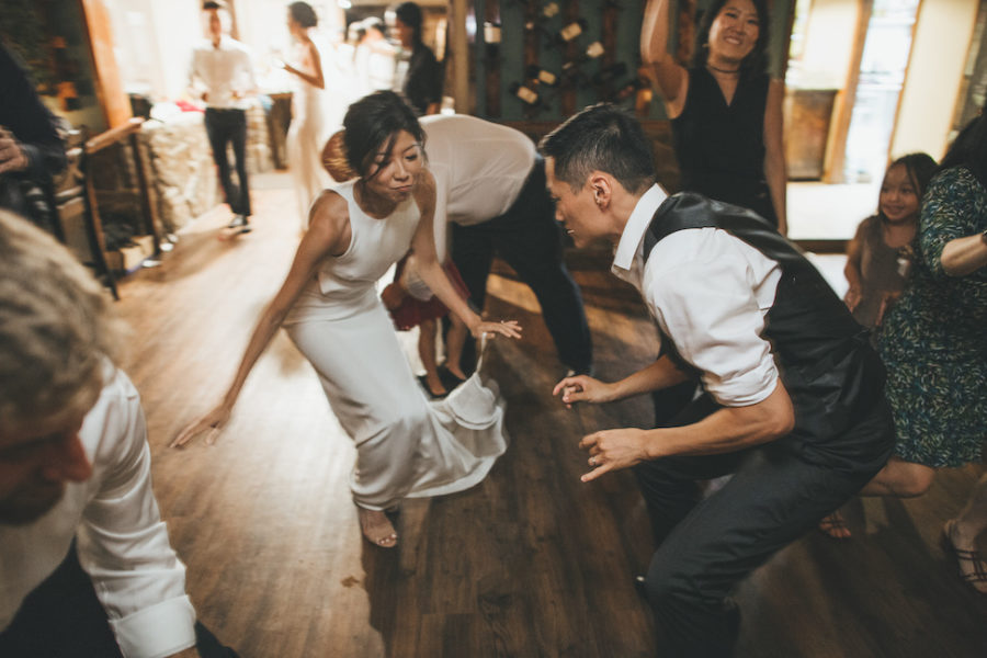 two people on the dance floor at their wedding reception getting down to the best wedding songs of 2019