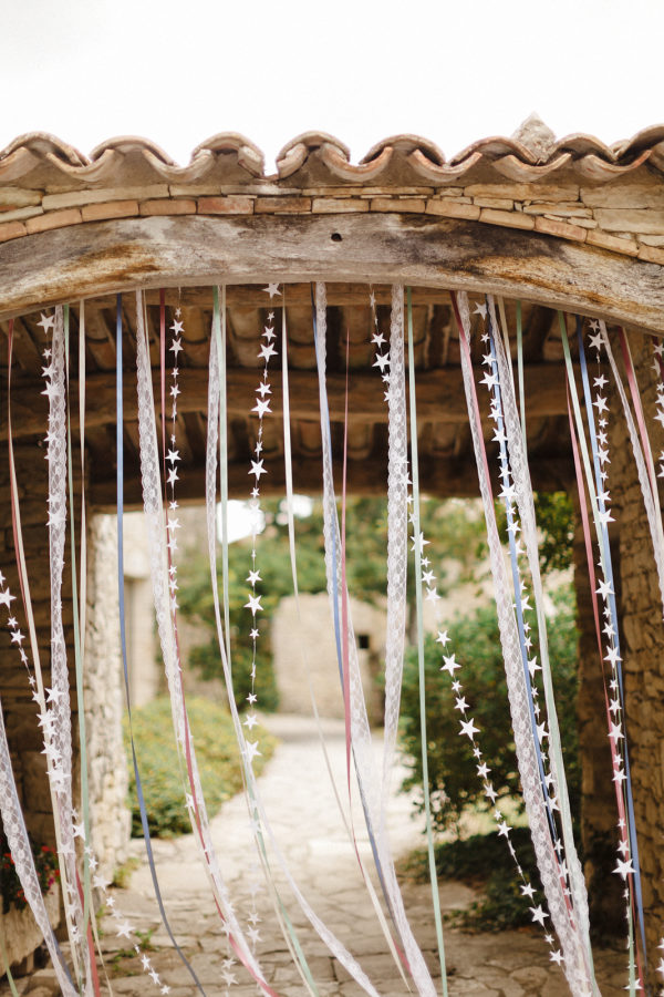 Streamers of stars and ribbons blowing in a doorway as an idea for bridal shower decorations