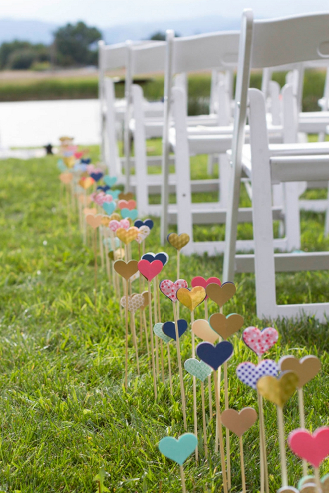 Hearts on sticks planted in the ground lining an aisle of chairs as an idea for bridal shower decorations