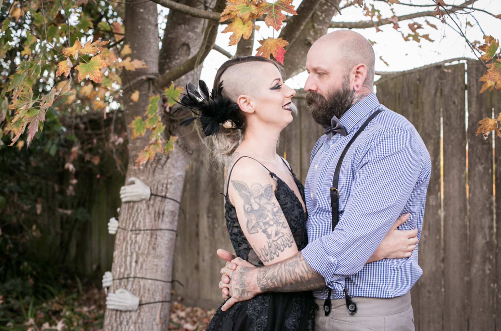 A couple staring into each other's eyes at their Halloween backyard wedding