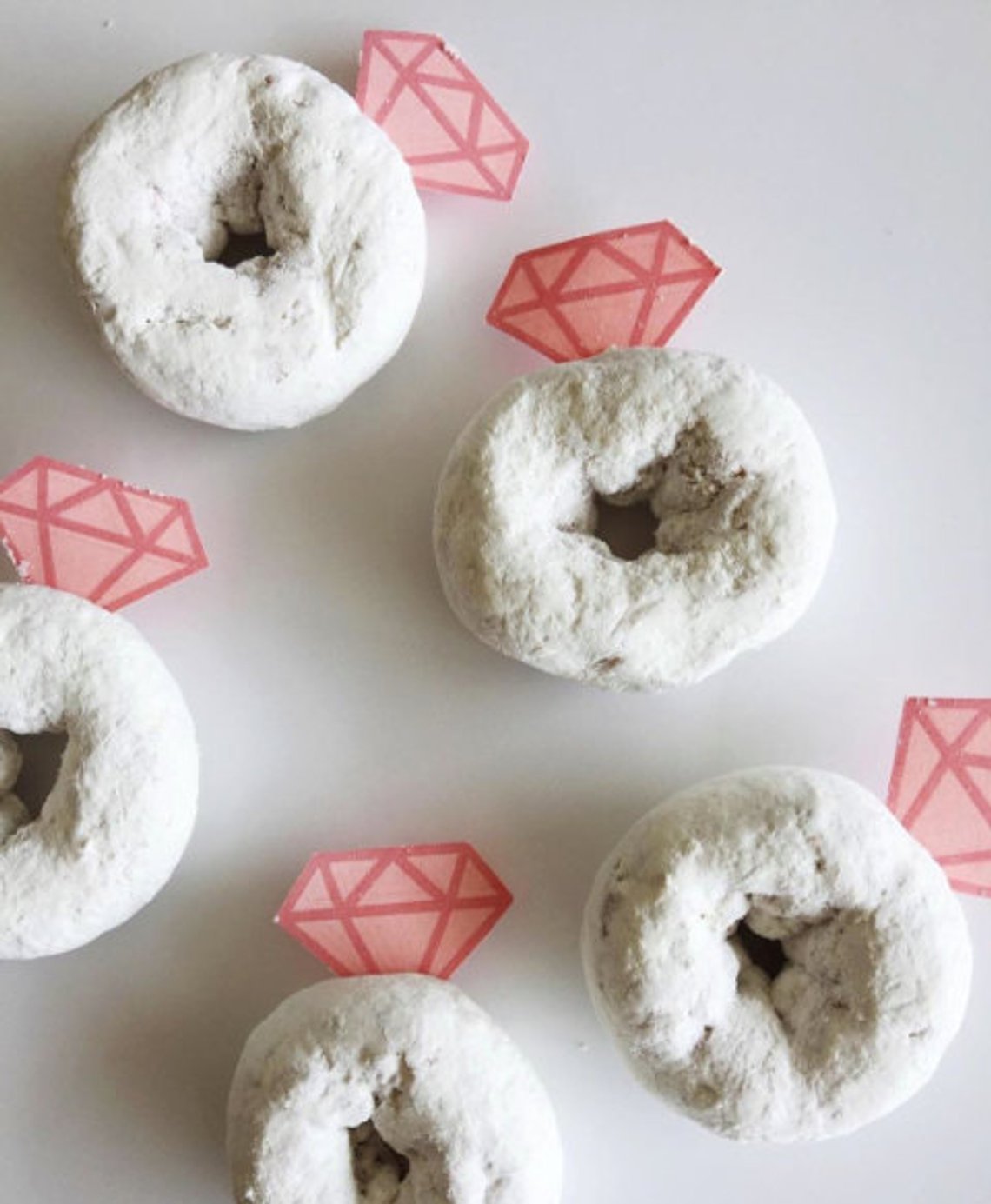 Powdered doughnuts with diamond decorations as an engagement party idea