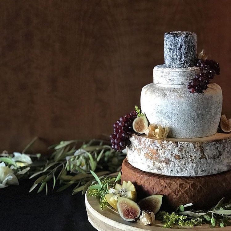 a five-tiered wedding cake made of cheese wheels