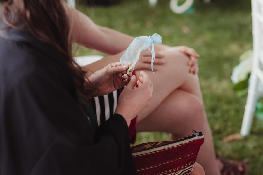 A guest holds a small wedding favor bag during a ceremony