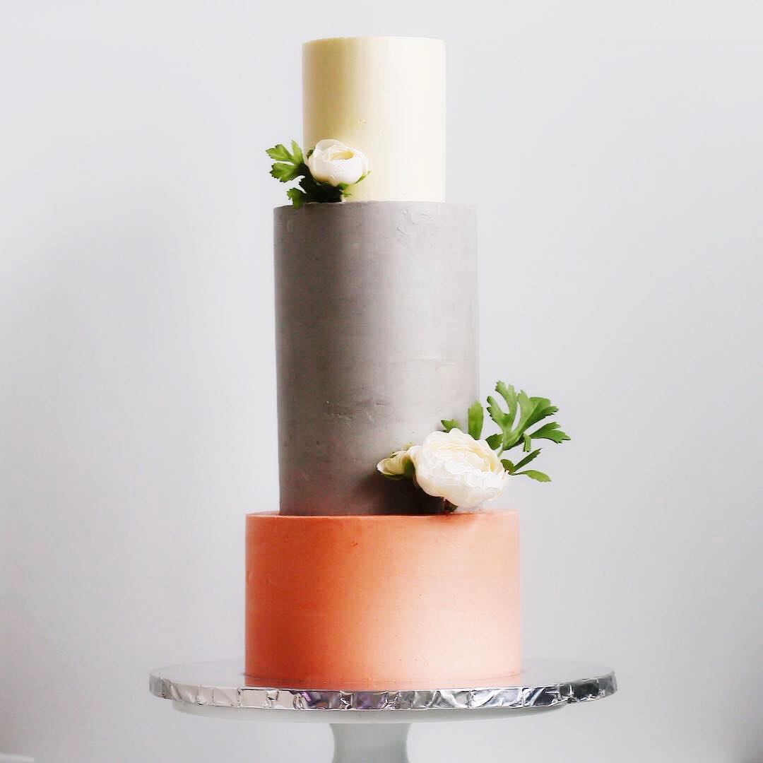 3-tiered white, grey and orange color block cake
