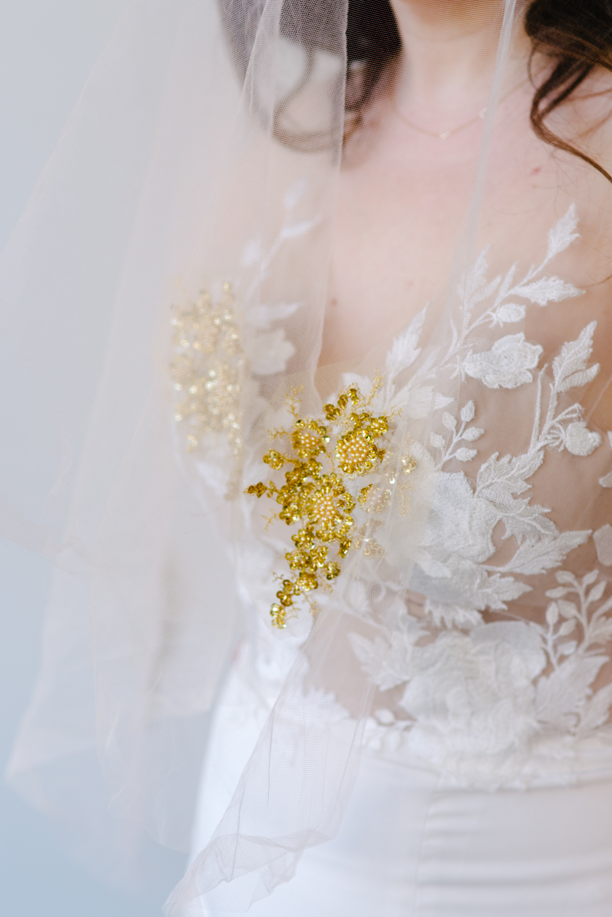 Close up of a gold appliqué attached to a wedding veil