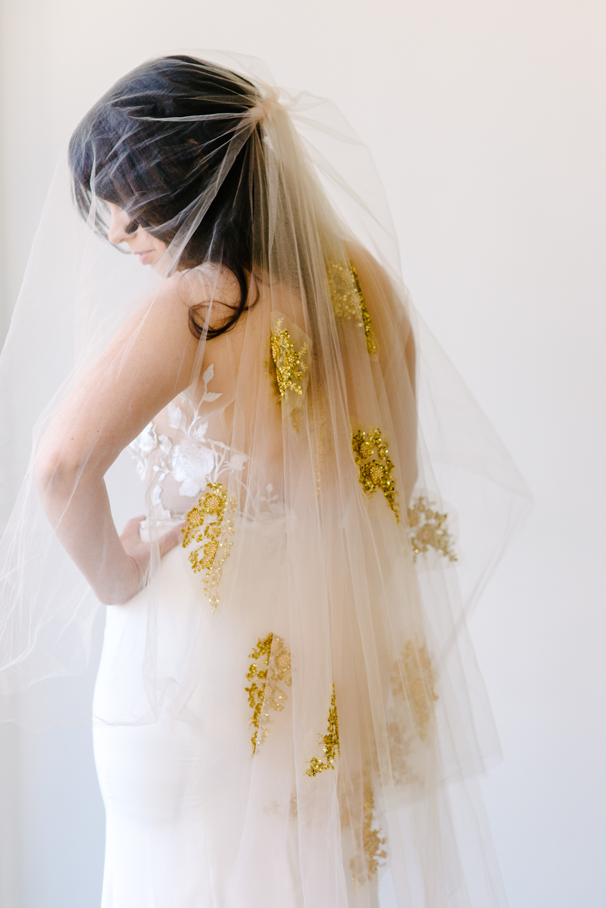 Reverse view of a wedding veil with gold appliqués attached