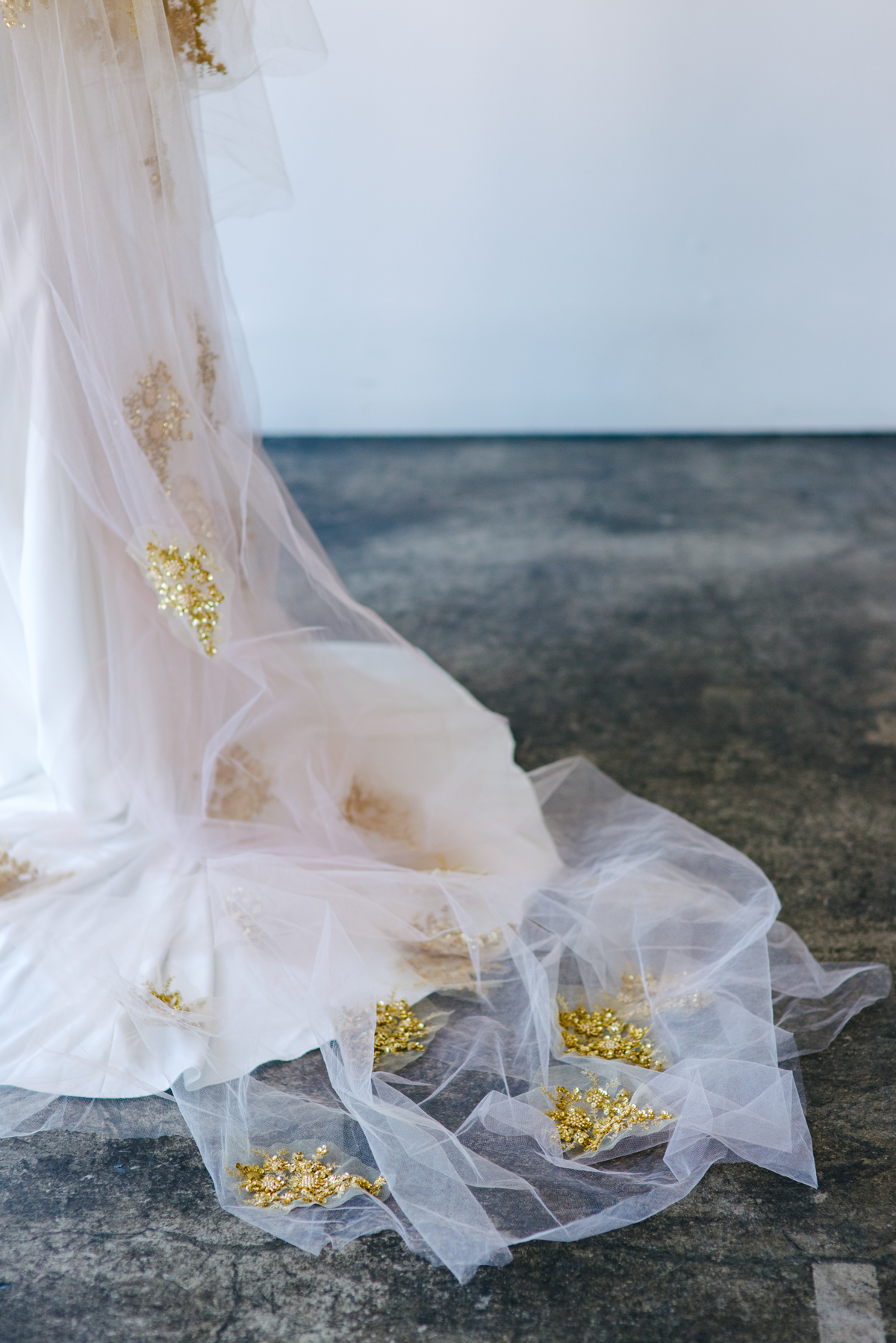 Close up of gold appliqués attached to a wedding veil