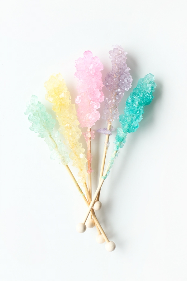 An assortment of rock candy on sticks on white background