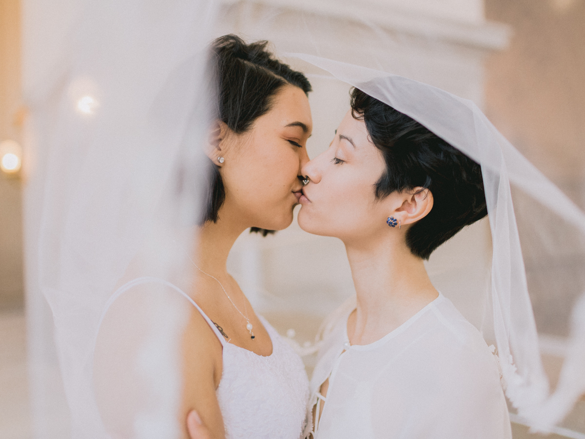 Two women kissing at their wedding