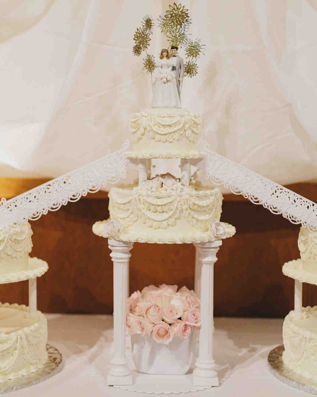 Two tiered elevated wedding cake with large cake toppers