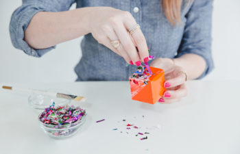 Woman sprinkling confetti on a craft
