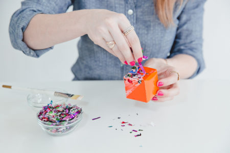 Woman sprinkling confetti on a craft