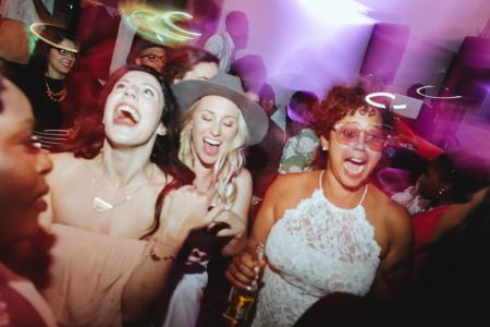 Two women dancing happily at their wedding reception