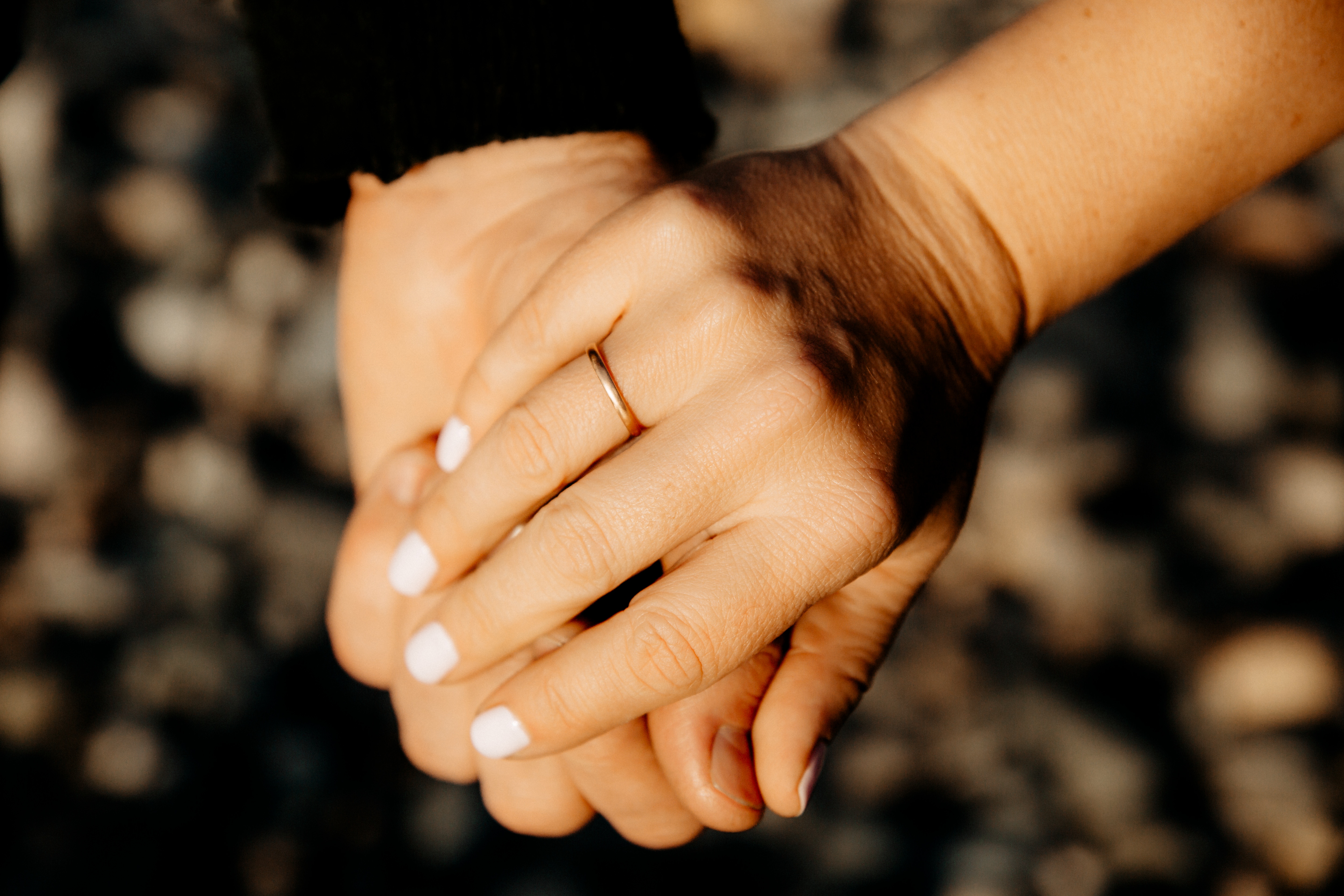 Close up of two hands holding each other