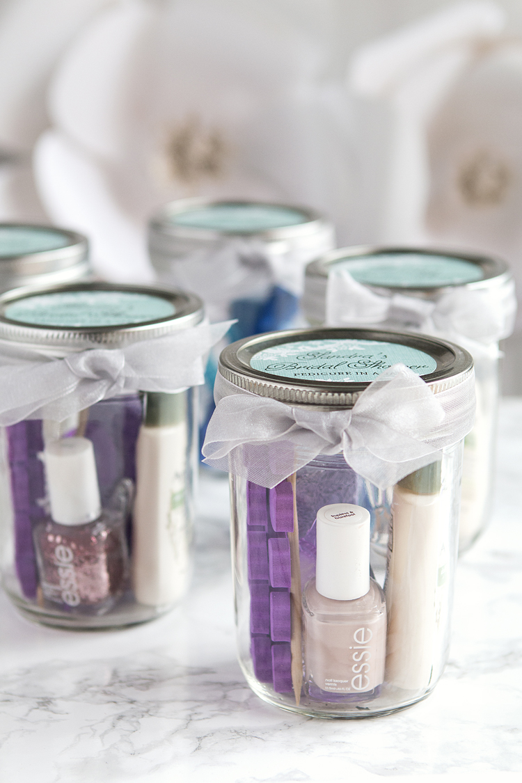beauty products packaged in jars and tied with bows for bridal shower favors