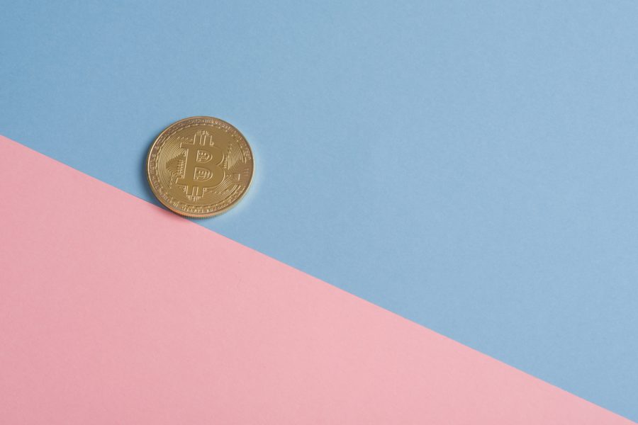 A coin placed on a backdrop of blue and pink