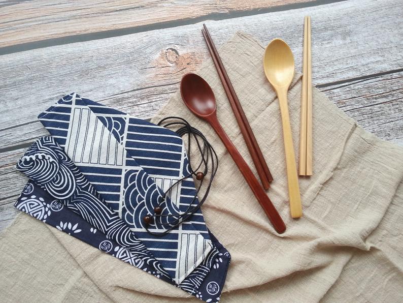 Bamboo utensils and printed carrying pouch on a napkin for bridal shower favors