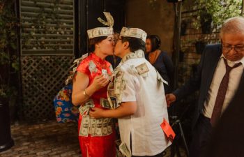 A wedding couple kiss during their 'money' dance