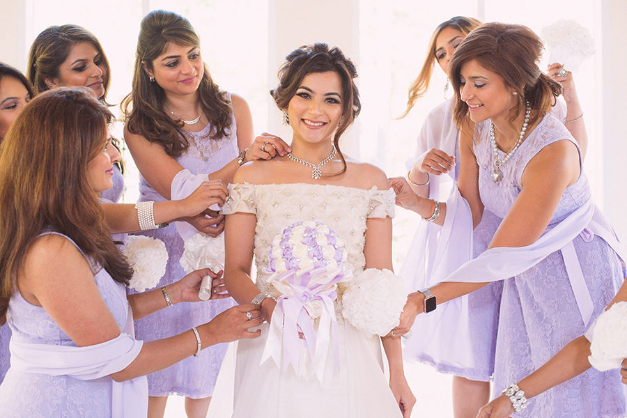 A bride is attended to by her bridesmaids